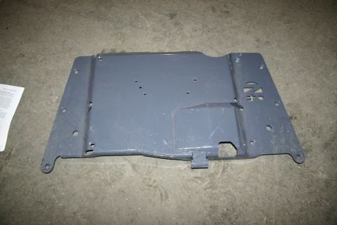 2003 Jeep TJ - A gray metal skid plate, possibly for a vehicle, is shown from a top-down perspective on a concrete floor.