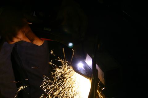 2003 Jeep TJ - Metal cutting process with sparks flying.