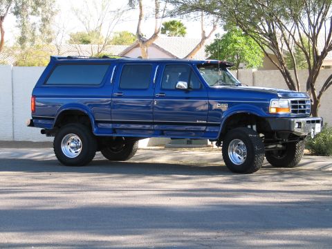 1996 Ford C-350 (Centurion Conversions) - This modified truck features a raised suspension and a custom camper shell, giving it an extended SUV-like appearance.