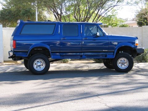 1996 Ford C-350 (Centurion Conversions) - Blue 1996 Ford C-350 (Centurion Conversions) extended cab pickup truck shown from the side.