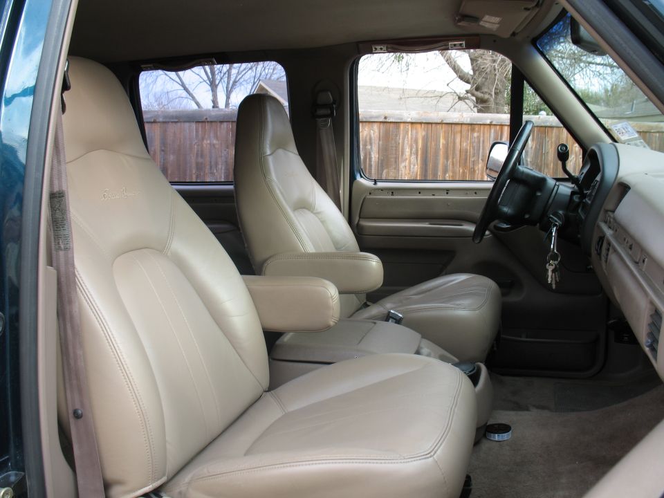 Tan leather bucket seats and dash interior of a truck with keys in ignition