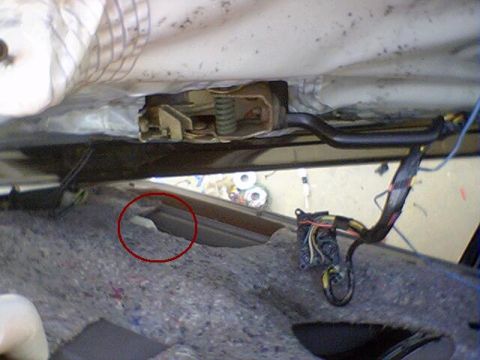 1994 Ford Bronco - Interior view of a car door with exposed latch mechanism and wiring during a repair process.