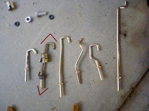 1994 Ford Bronco - Assortment of metal rods and fasteners laid out on a concrete floor.