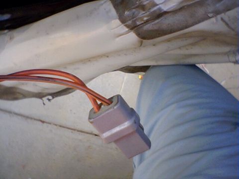 1994 Ford Bronco - Close-up of a wiring harness connector with orange wires, likely from a vehicle's interior.