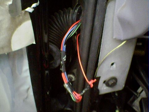 1994 Ford Bronco - Close-up of exposed wiring within a vehicle's door jamb area.