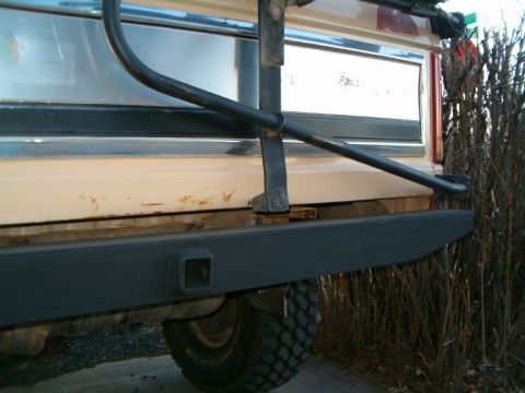 1985 Ford Bronco - Rear view of a 1985 Ford Bronco, showing the bumper and a tire.
