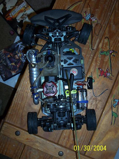 1994 Ford Probe - A detailed view of a remote control car chassis, showing its engine and mechanical parts.