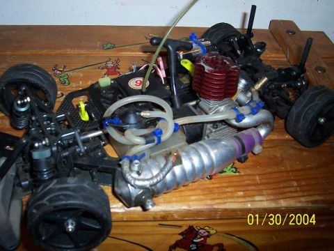 1994 Ford Probe - Close-up view of a remote control car's engine and chassis, showing intricate mechanical details and components.
