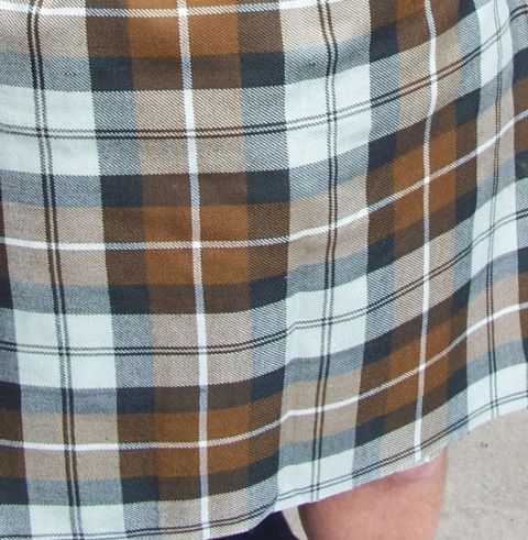 1990 Ford Bronco - Fabric with a plaid pattern in brown, white, and gray tones.