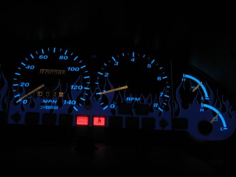 1997 Ford Probe - Custom dashboard gauges with a flame motif illuminate the interior, displaying speed, engine revs, and fuel status.