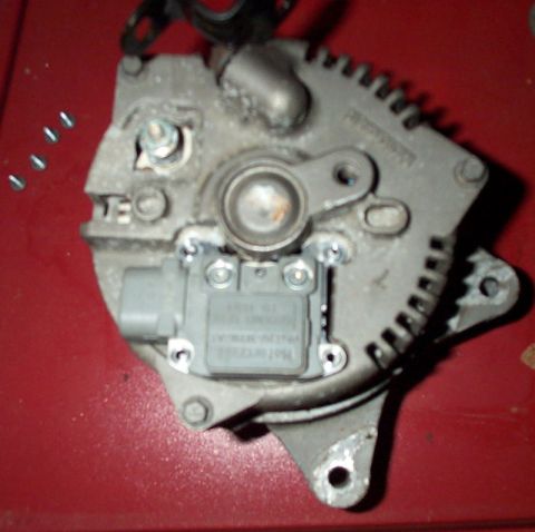 1993 Mercury Grand Marquis - When the screws are removed the voltage regulator will be pushed up by the brushes.