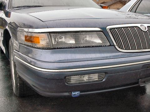 1985 Mercury Grand Marquis - Front view of a dark blue Mercury Grand Marquis, showing the grille and headlights.