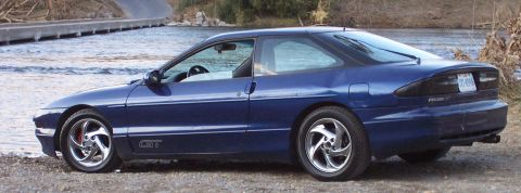 1994 Ford Probe - A blue 1994 Ford Probe GT is seen from the side near a body of water.