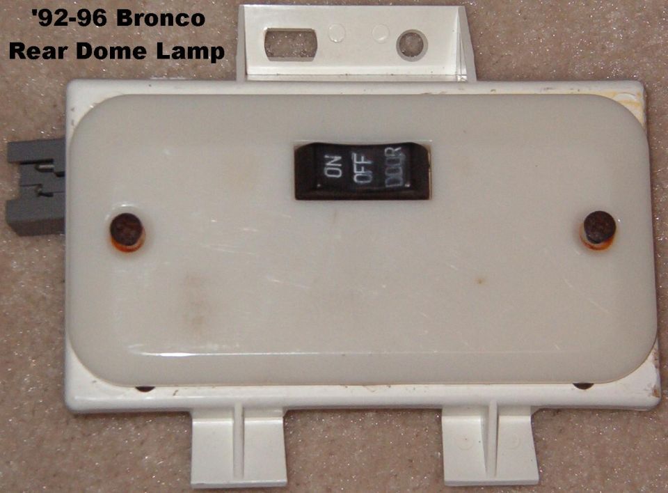White rear dome lamp housing with ON OFF DOOR switch, labeled 92-96 Bronco rear dome lamp