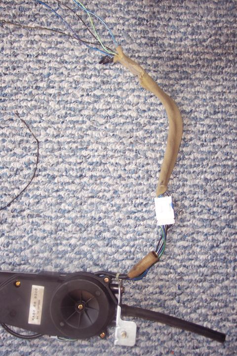 1995 Ford Probe - A power antenna motor assembly with wiring is shown. Text on the motor reads 'WARD 90 9000'.