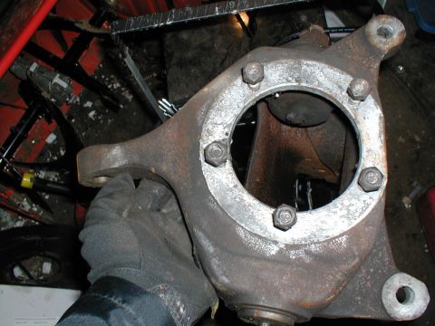 1979 Ford Bronco - A gloved hand holds a rusty metal part, likely from a vehicle's suspension system. The Supermotors.net logo is visible in the lower right c…