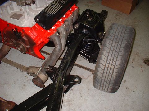 1964 Ford Galaxie - Various automotive parts, including an engine and suspension assembly, are shown disassembled on a workshop floor.