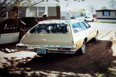 1972 Ford Ranchero - Station wagon parked in front of mobile homes, with another vehicle in the background.