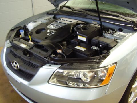 1997 Ford Taurus - The engine bay of a silver car is shown with the hood open. The SuperMotors logo is visible in the lower right corner.