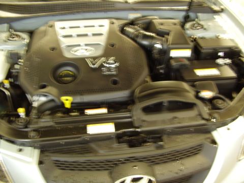 1997 Ford Taurus - Close-up view of a V6 3.3 liter engine in a vehicle's engine bay.