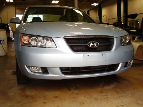 1997 Ford Taurus - Front view of a light blue Hyundai sedan, likely a Sonata from the mid-2000s.