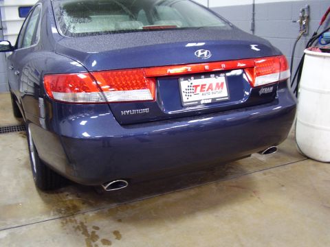 1997 Ford Taurus - The rear of a blue Hyundai Azera is visible, with a dealership plate and the Hyundai logo.
