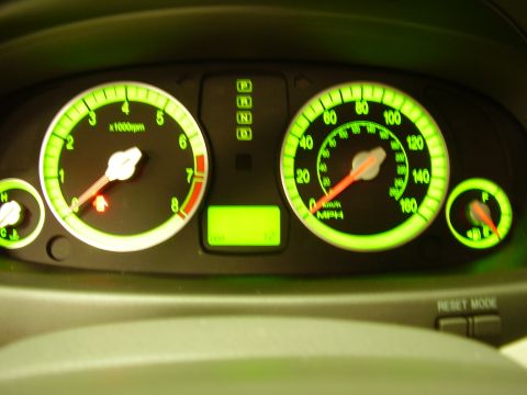 1997 Ford Taurus - The illuminated dashboard gauges display the tachometer, speedometer, and fuel level, with gear selection indicators visible.