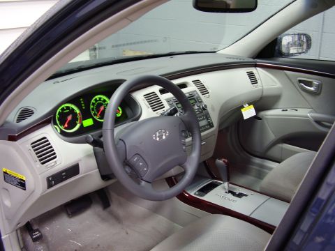 1997 Ford Taurus - Interior view of a car's dashboard, steering wheel, and center console with automatic transmission shifter.