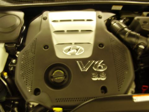 1997 Ford Taurus - Close-up of a vehicle's engine cover, a V6 3.8 designation and the Hyundai logo.