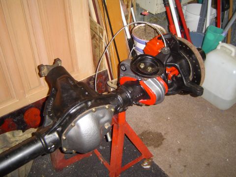 1989 Ford Bronco - A rear axle assembly, likely for a truck or SUV, is shown on a red stand with its brake components visible.