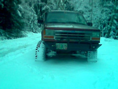 1991 Ford Explorer - 1991 Ford Explorer driving in snowy conditions on a dirt road.