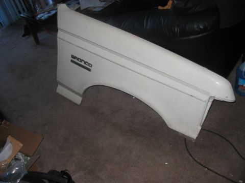 1991 Ford Bronco - White fender with 'BRONCO' badging, likely for a 1991 Ford Bronco.