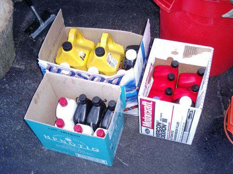 1992 Ford Bronco - Boxes of automotive fluids, including Motorcraft Mercon/Dexron III, are stored on the ground.