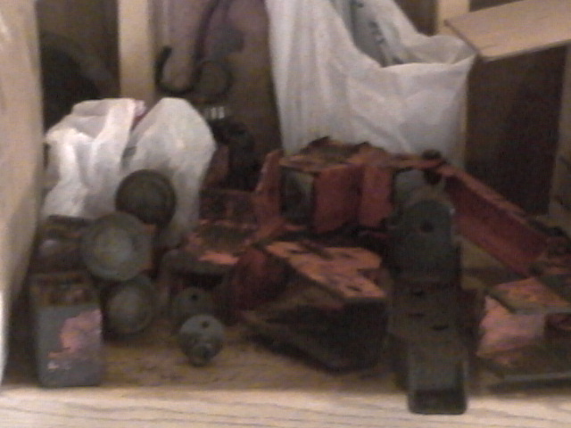 Pile of assorted vehicle parts, some red, some metallic