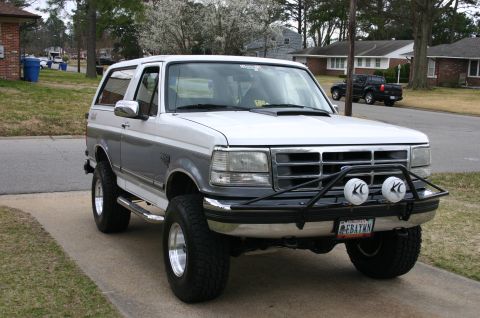 1994 Ford Bronco - This two-tone Ford Bronco features KC lights and aftermarket wheels.