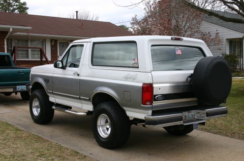 1994 Ford Bronco - This 1994 Ford Bronco features a two-tone paint scheme and a rear-mounted spare tire.