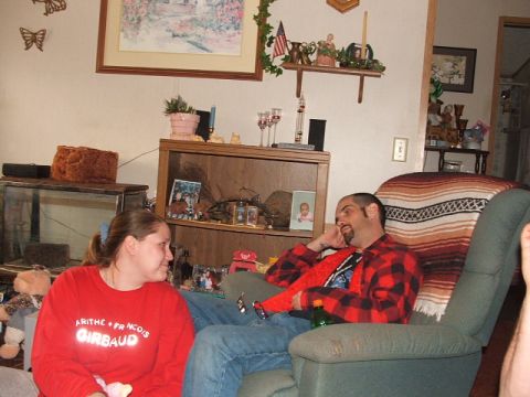 1966 Ford Ranchero - A man and woman relax in a living room, with decorations and personal items visible in the background.