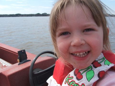 1966 Ford Ranchero - A young girl smiles while on a boat ride, with a cherry-patterned life vest.