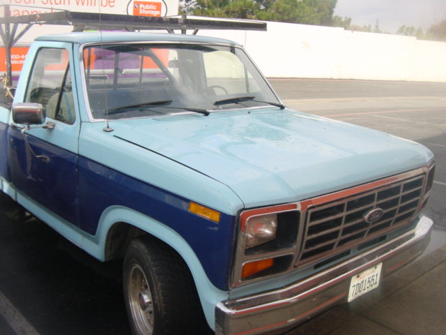 Two-tone blue pickup truck front 3/4 view. License plate 70D1551