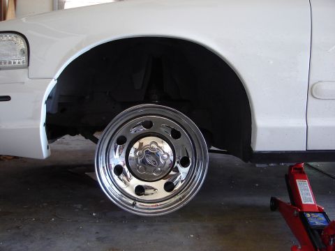 2000 Ford Crown Victoria - Front wheel of a 2000 Ford Crown Victoria removed for service, revealing the chrome hubcap.