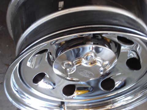 2000 Ford Crown Victoria - Close-up of a shiny chrome wheel and a hubcap the Ford logo.