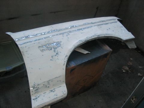 1991 Ford Bronco - This is a car fender, likely undergoing restoration or repair work.
