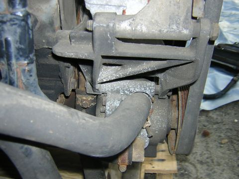 1979 Ford Bronco - A close-up view of an engine component, showing hoses and a belt, with visible rust and wear.