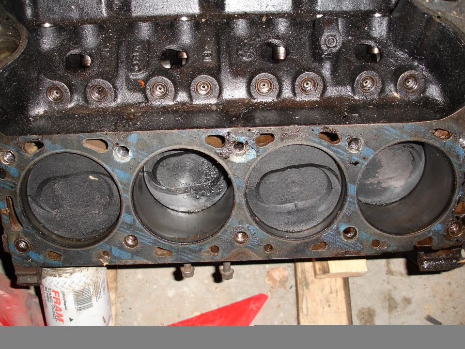 Engine block showing four cylinders with pistons. A FRAM oil filter is visible below