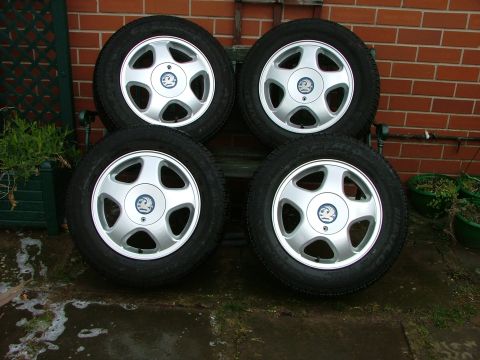 2001 Ford Fiesta - Set of four tires and wheels, likely for a Vauxhall vehicle, displayed outdoors.