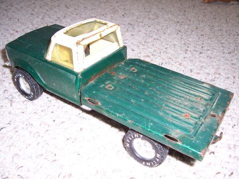 1978 Ford Bronco - This green toy truck features a white roof with a sunroof and a flatbed, seen from a rear 3/4 angle.