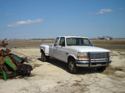 1992 Ford Bronco - This white 1992 Ford F-350 dually pickup truck is parked in a rural setting.