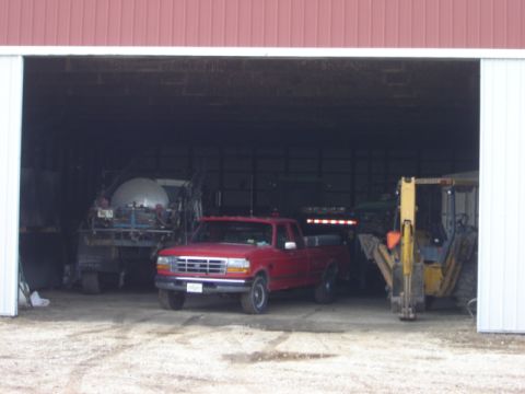 1992 Ford Bronco - Red 1992 Ford F-150 pickup truck is parked inside a barn with other farm equipment.