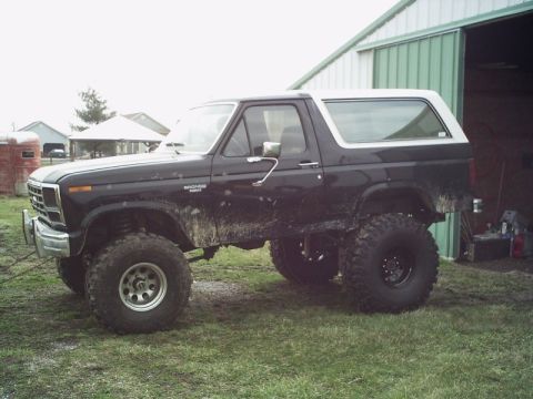 1986 Ford Bronco - This lifted 1986 Ford Bronco is shown in a side profile, appearing muddy and ready for off-road adventure.