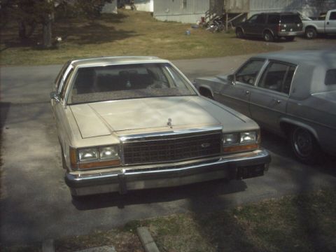 1985 Ford Crown Victoria LTD - Front view of a 1985 Ford Crown Victoria LTD, parked next to another sedan.